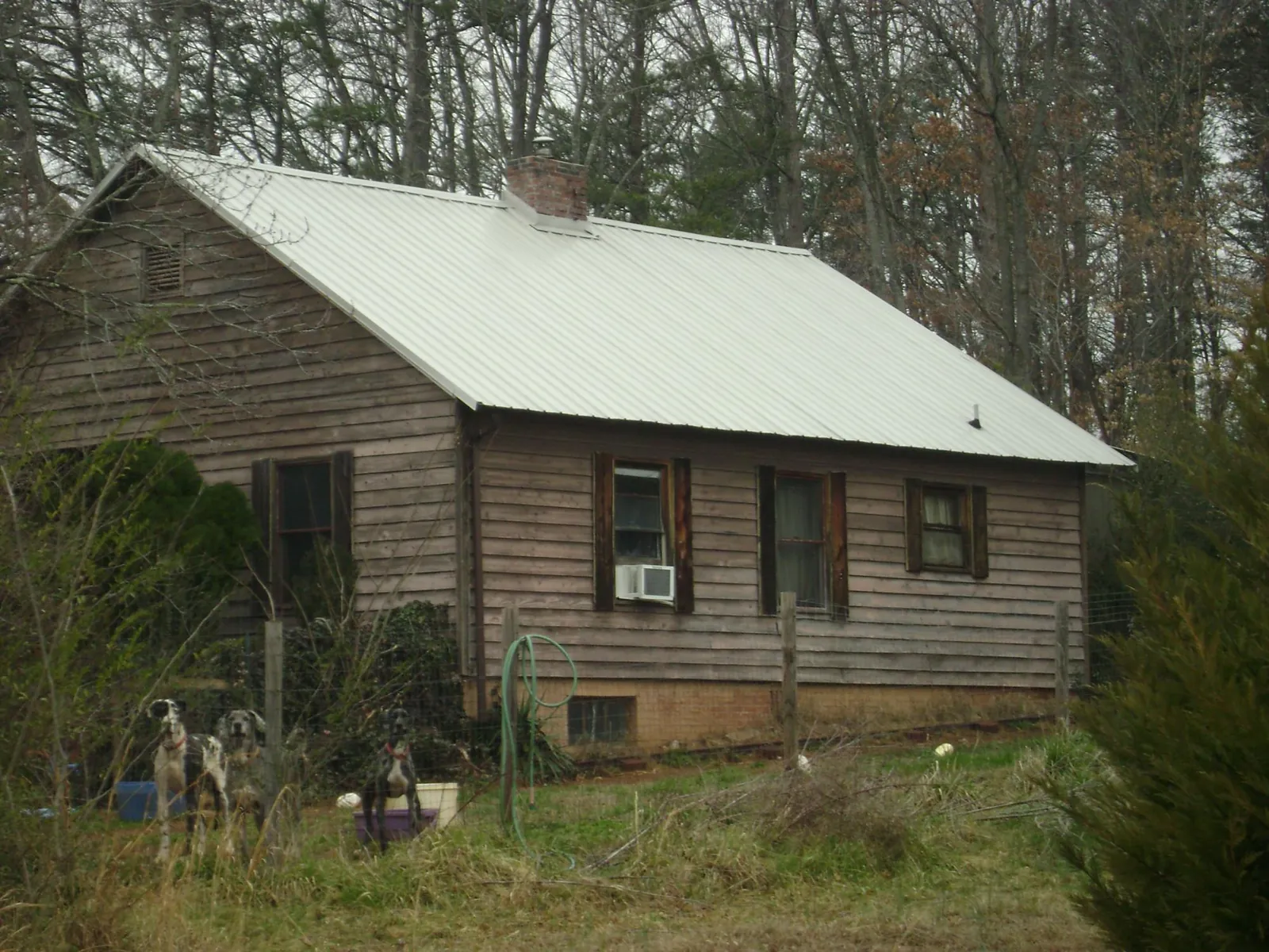White metal roof on an old wood sided farmhouse, from a Metal Roof Installation job in Kiel